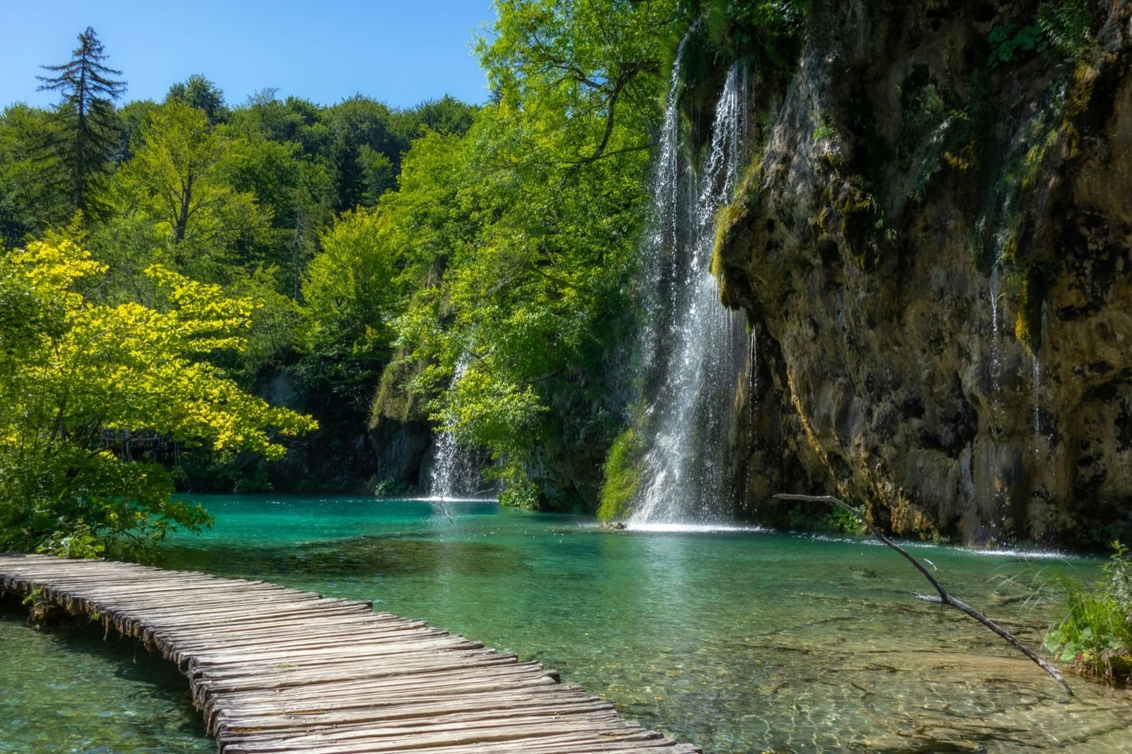 Wooden boardwalk leading to a waterfall at Plitvice Lakes