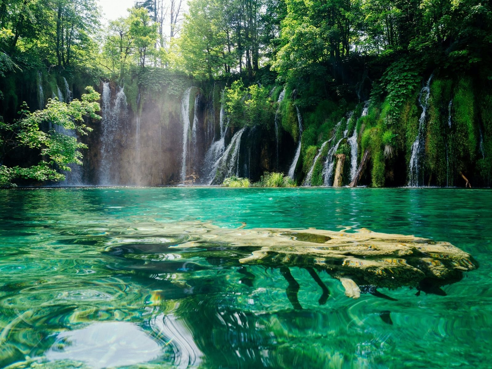 Waterfalls cascading into the turquoise lakes of Plitvice